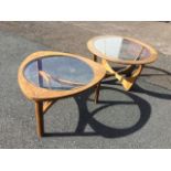 A circular 60s teak Ercol coffee table with plate glass panel in frame on curved supports having