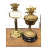 A Victorian brass oil lamp with chamfered bun shaped glass reservoir on fluted column above weighted