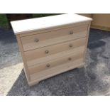 A modern oak chest of three long drawers mounted with metal knobs, having limed type finish. (35.5in