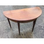 A ‘D’ shaped nineteenth century mahogany table, with crossbanded frieze raised on square tapering