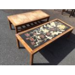 A rectangular 60s teak coffee table inset with floral art nouveau style lily panel, raised on square