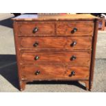 A George IV mahogany chest of drawers, the top with rounded corners on fluted columns framing two