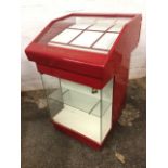A Cartier jewellery display cabinet, the angled glass top displaying trays with roller drawer,