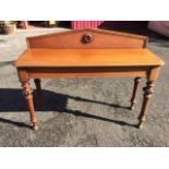 A nineteenth century mahogany hall table, the upstand with circular carved medallion in moulded