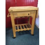 A Servus beech kitchen trolley with butcher block type top above a frieze drawer and side rail, with