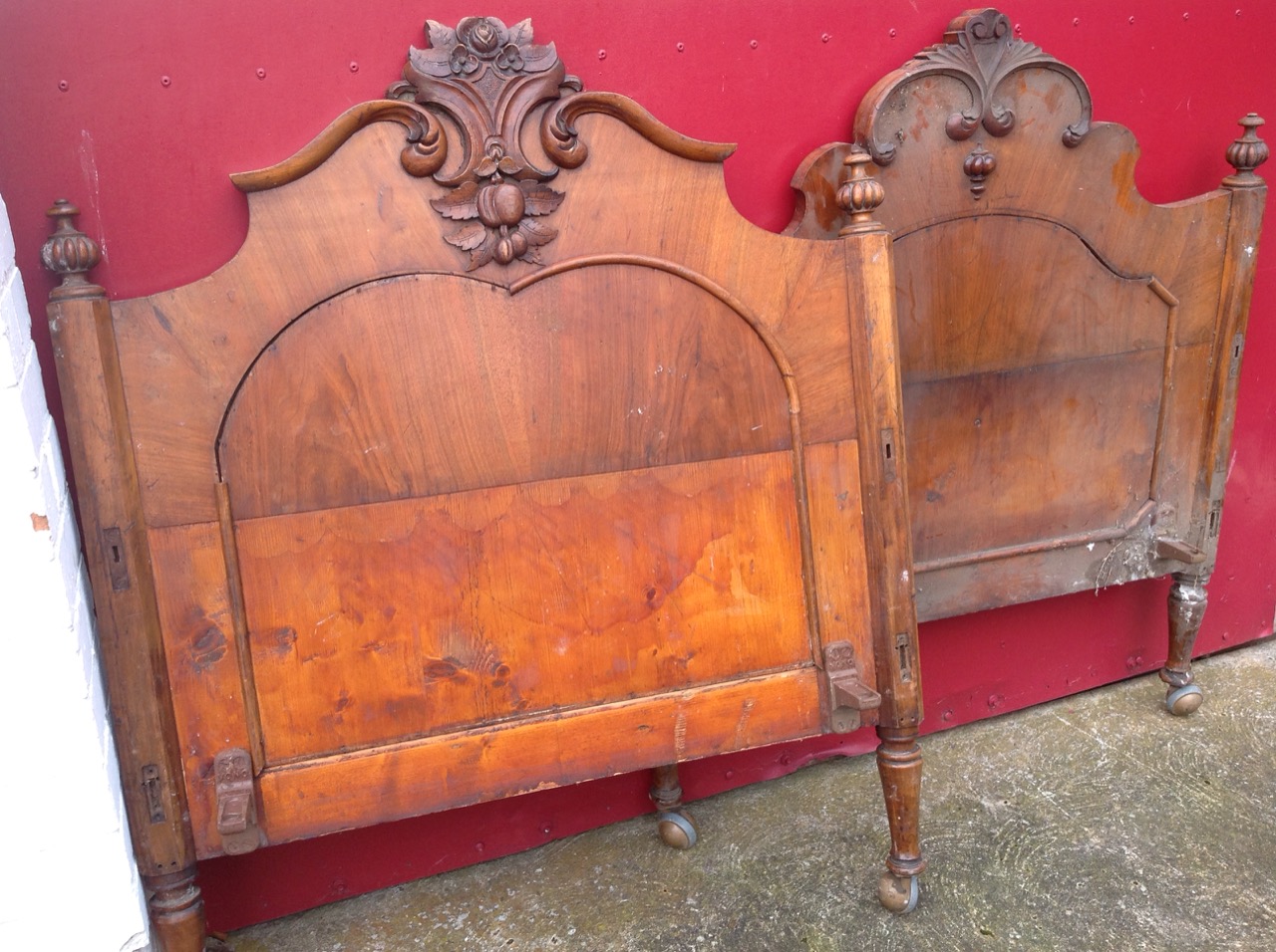 A Victorian carved walnut single bed, the head & tailboard with foliate scrolled crests, having