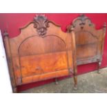 A Victorian carved walnut single bed, the head & tailboard with foliate scrolled crests, having