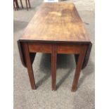 A Georgian mahogany dining table, the rectangular top with two rounded drop-leaves raised on six