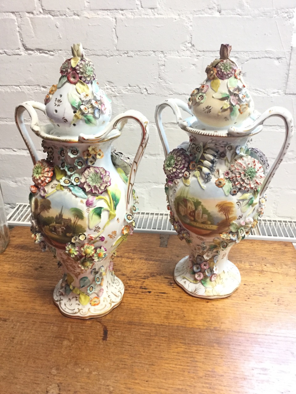 A pair of nineteenth century Staffordshire Coalport style vases and covers, heavily encrusted with