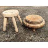 A painted ash five legged circular milking stool; and another moulded hardwood stool on three turned
