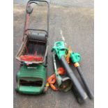 A Black & Decker electric leaf blower; a Qualcast electric lawn scarifier with box; and a Black &