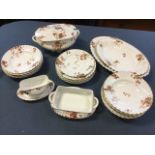 A Haviland Limoges porcelain dinner service, the gadrooned moulded pieces decorated with autumn