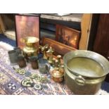 A hand beater brass jardiniere with ring handles; a flared brass vase; a pair of brass fawn book-