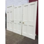 A pair of painted Victorian pine panelled doors, converted into firedoors, with brass knob handles -