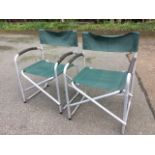 A pair of folding tubular aluminium framed armchairs with fabric backs & seats. (2)