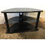 A rounded corner TV stand with glass shelf on column supports. (32in x 18in x 19in)