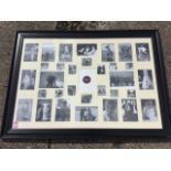 A large modern family photo frame with thirty-three mounts, the frame with ebonised moulding. (