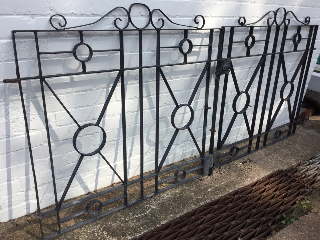 A pair of wrought iron driveway gates with scrolled crests above rectangular panels centred by - Image 2 of 3