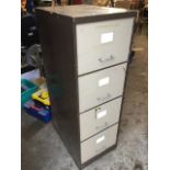 A filing cabinet with four drawers having label holders and tubular handles. (17.75in x 24.5in x