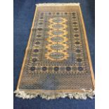 An oriental rug woven with field of six quartered oval medallions in grid, framed by frieze of