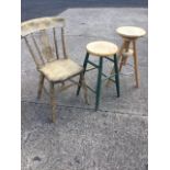 An elm seated kitchen chair with circular medallion to splat, raised on turned legs & stretchers;