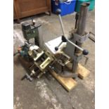 A Proxxon bench drill mounted on wood block with vice; two Axminster adjustable bench vices; and a