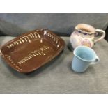 A nineteenth century terracotta slipware dish of rectangular rounded form having scrolled