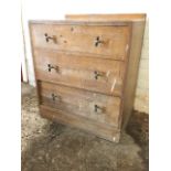 A 30s oak chest of drawers with three long graduated drawers on plinth, mounted with original chrome