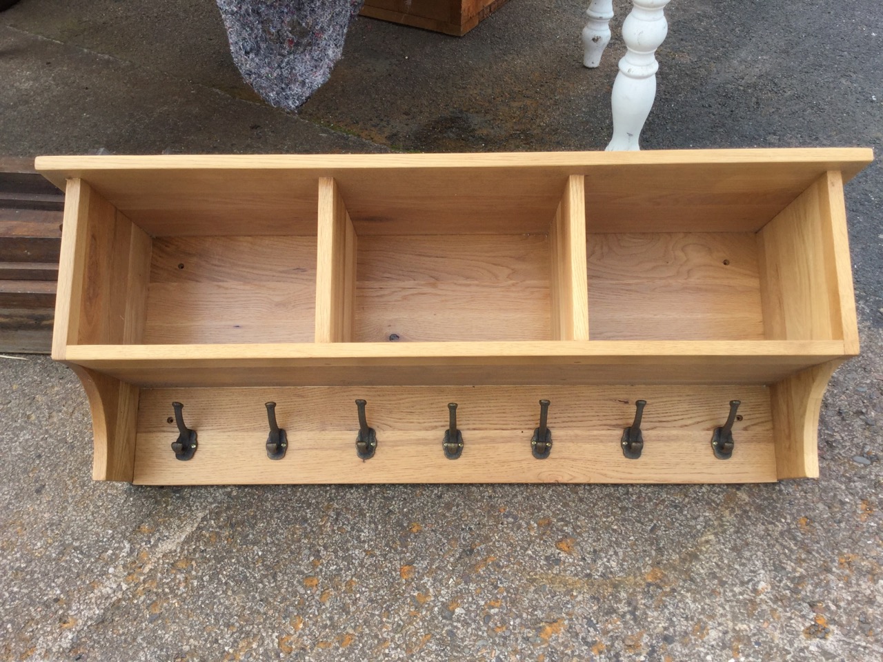 A contemporary oak hall rack, with shelf above three open compartments, having row of seven brass - Image 2 of 3