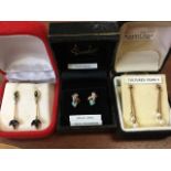 A cased pair of 9ct gold opal & diamond earrings with claw shaped mounts; a cased pair of 9ct gold