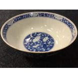 A Chinese blue & white bowl decorated with prunus blossoms raised on tubular foot - four character