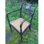 A regency painted armchair, the back with panel painted en grisaille with cherubs above latticework,