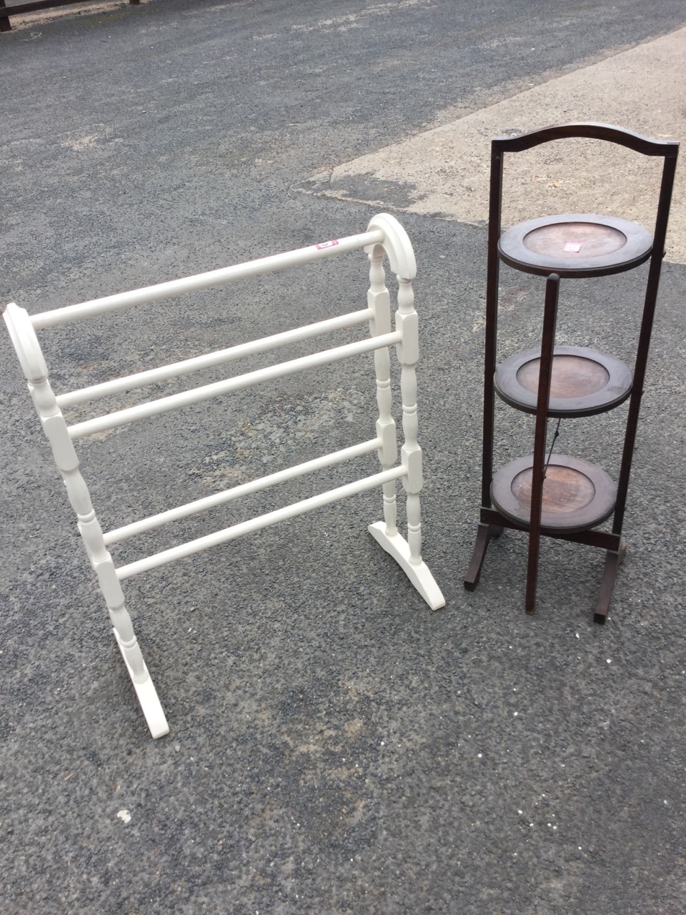 A painted Victorian style towel stand with five rails on twin turned columns beneath arched