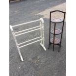 A painted Victorian style towel stand with five rails on twin turned columns beneath arched