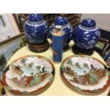 Three Chinese blue & white ginger jars & covers on carved hardwood stands; a tubular tapering