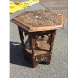 A nineteenth century hexagonal carved eastern table, the moulded top with blind fretwork carved star