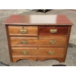 An Edwardian mahogany chest with two short and two long ribbed drawers mounted with brass plate