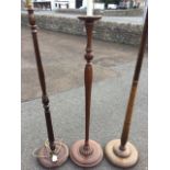 A mahogany standard lamp with leaf carved fluted column on circular base; a stained standard lamp