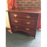 A mahogany chest with rectangular moulded top above three long drawers mounted with brass plate