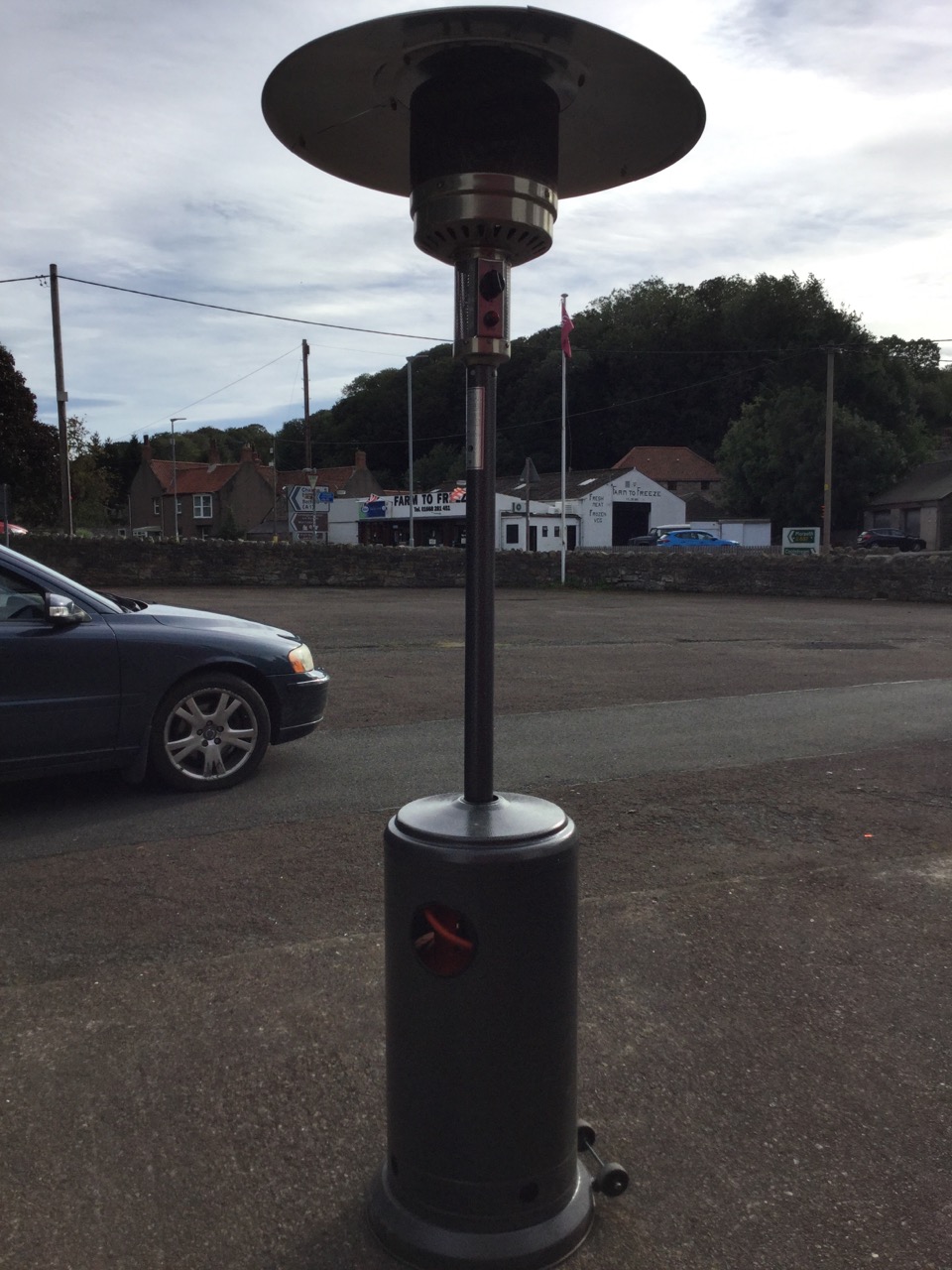 A gas patio heater with gauze reflector on column above a tubular base on casters, complete with a - Image 2 of 3