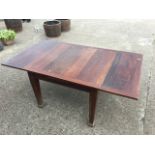 A mahogany draw-leaf dining table, the panelled rectangular top on square tapering legs. (71in x
