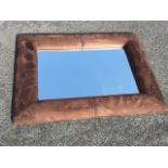 A contemporary rectangular mirror, the bevelled plate in padded faux suede cushion frame. (32.5in
