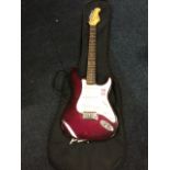 A Tanglewood electric guitar - Nevada FST32K, the maroon bodied instrument with three pick-ups, with