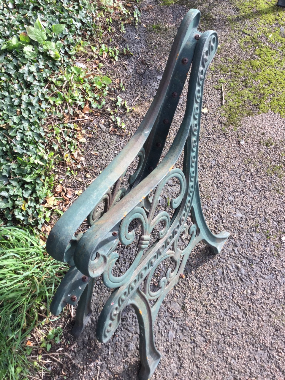 A pair of cast iron bench ends with pierced scrolled decoration on channelled sabre legs. (2) - Image 3 of 3