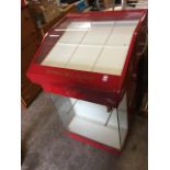 A Cartier jewellery display cabinet, the angled glass top with roller drawer, having glazed cupboard