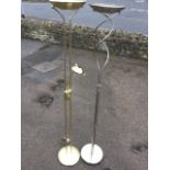 A contemporary brush brass uplighter and reading lamp on twin column stand, raised on circular domed