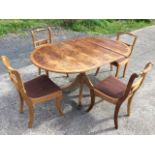 A reproduction yew dining table, together with a set of four regency style dining chairs, the