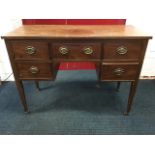 A Georgian style mahogany dressing table, the rectangular top above a kneehole with fitted frieze