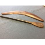 A large hardwood boomerang; and an antique nineteenth century African hardwood stirrer, the shaft