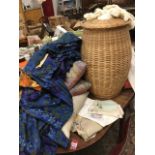 Miscellaneous textiles, including embroidery, cushions, a cane laundry basket, a patchwork style bed